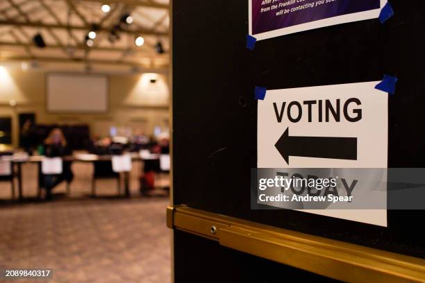 Poll workers wait for voters during the Ohio primary election at Dwell Community Church on March 19, 2024 in Columbus, Ohio. Early voting numbers...