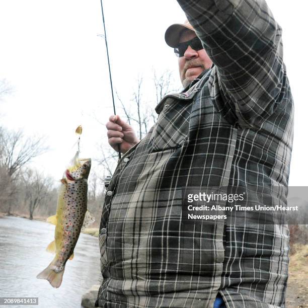 Marty Bayles of Edinburg brings in a brown trout on the Kayaderosseras Creek as today marks the traditional start of trout season in NYS Friday April...