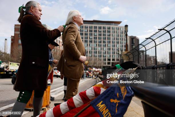 Boston, MA Lexington Minute Men re-enactor Steve Conners helped to tie a green ribbon into the hair of fellow Lexington Minute Man Chris Hurley...