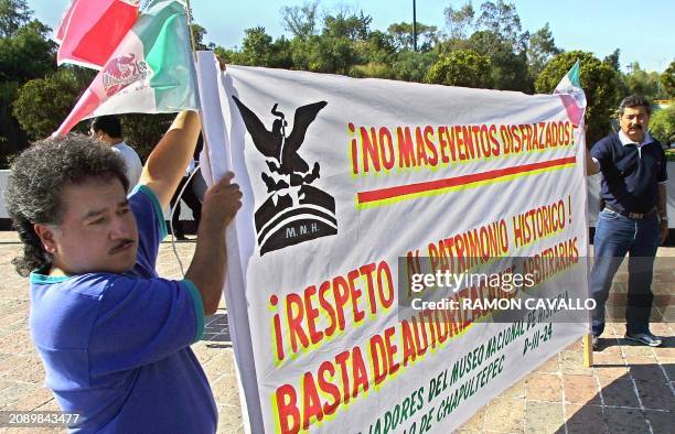 Demonstrators are seen in Mexico City protesting the upcoming appearance of pop icon Elton John 21 October 2001. Miembros del Sindicato de...