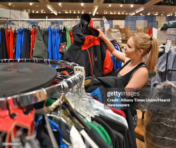 Alpin Haus employee Serenity Lyons arranges a clothing display for this weekend's the Northeast Ski & Craft Beer Showcase at the Empire State Plaza...