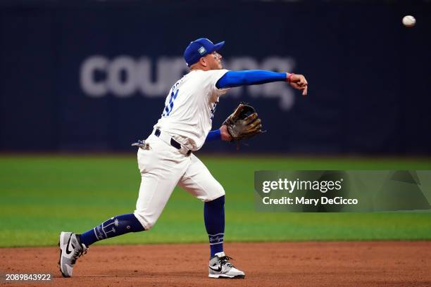 Miguel Rojas off the Los Angeles Dodgers throws to first base for the out during the 2024 Seoul Series game between the Team Korea and the Los...
