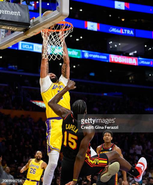 Los Angeles Lakers forward Anthony Davis scores against Atlanta Hawks center Clint Capela in the first half at Crypto.com Arena on March 18, 2024 in...