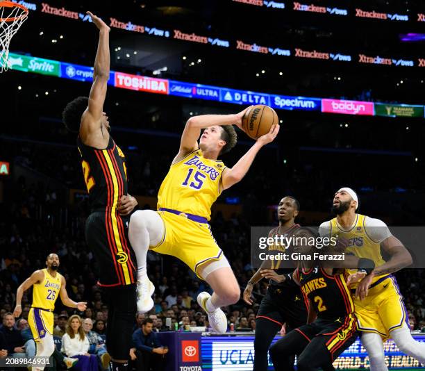 Los Angeles Lakers guard Austin Reaves drives to the basket against Atlanta Hawks forward De'Andre Hunter in the first half at Crypto.com Arena on...
