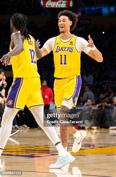 Los Angeles Lakers center Jaxson Hayes reacts with Los Angeles Lakers forward Taurean Prince and Prince hit a three-point shot in the fourth quarter...