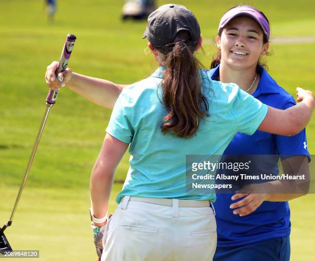 Isabella Diaz of Ballston Spa gets a hug from Laura Rentz, left, after Diaz won the Northeastern New York PGA's Junior Golf Tour Saturday August 12,...
