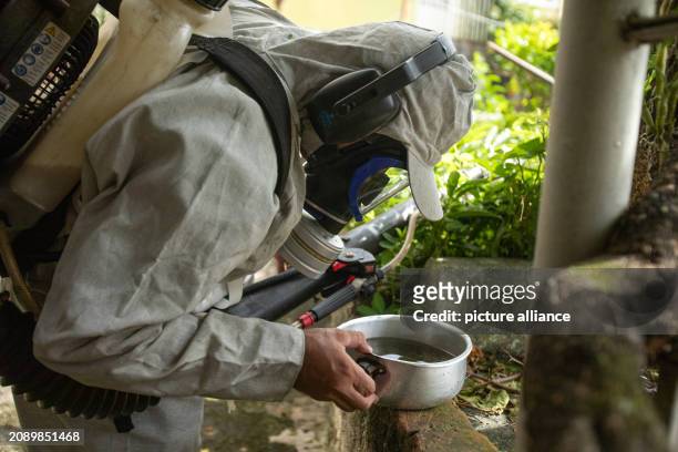 March 2024, Brazil, Sao Paulo: A city worker fumigates a neighborhood in the north of the city in the fight against the Egyptian tiger mosquito ,...