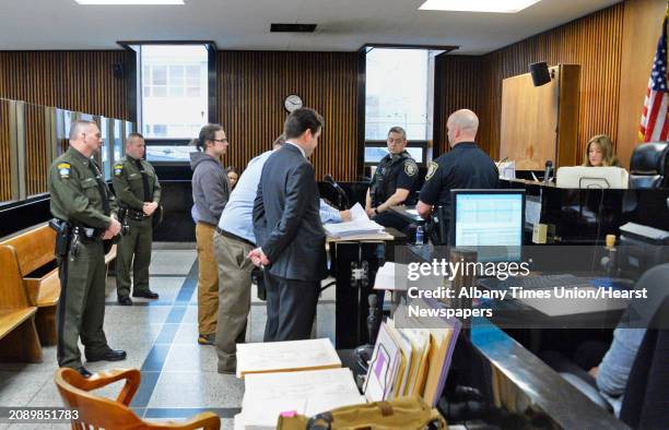 Town of Bolton's chief operator of its water department Thomas French II, center in hoodie, is arraigned before Judge Holly Treadler, right, in...