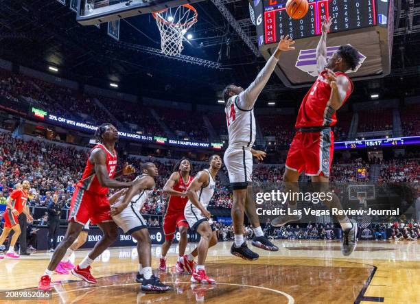 New Mexico Lobos guard Jamal Mashburn Jr. Elevates to get off a shot over San Diego State Aztecs guard Reese Waters during the second half of their...