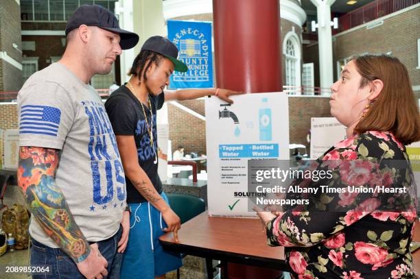 Environmental science classmates John Kent, left, Tyrique Hagood and Brittney Armstrong discuss Armstrong's presentation during Schenectady County...