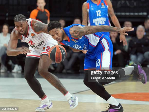 Tyrique Daniel Jones of Anadolu Efes in action against Moses Wright of Olympiakos during the Turkish Airlines Euroleague 30th week match between...
