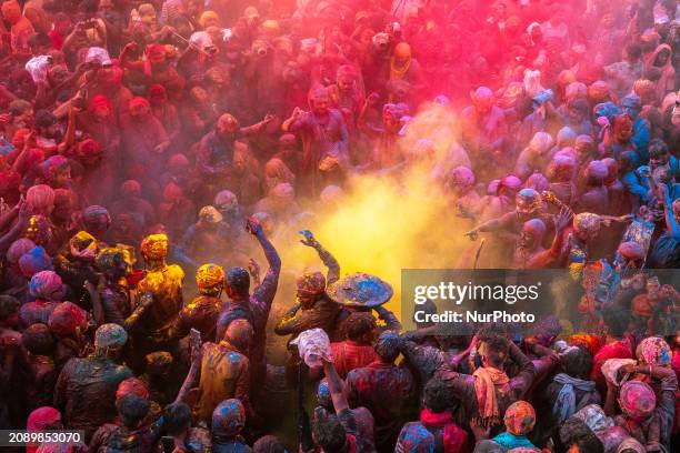 Hindu devotees are gathering at Nandbhavan Mandir in Mathura, Nandgaon Rural, Uttar Pradesh, India, on March 19 to play Holi by throwing different...