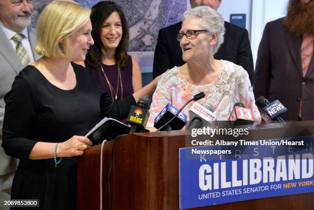 Senator Kirsten Gillibrand, left, is joined at the podium by Kennedy Towers resident Michelle Loiselle- Collis during a news conference to announce...