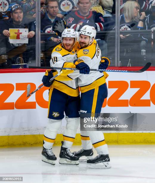 Gustav Nyquist and Filip Forsberg of the Nashville Predators celebrate a third period goal against the Winnipeg Jets at Canada Life Centre on March...