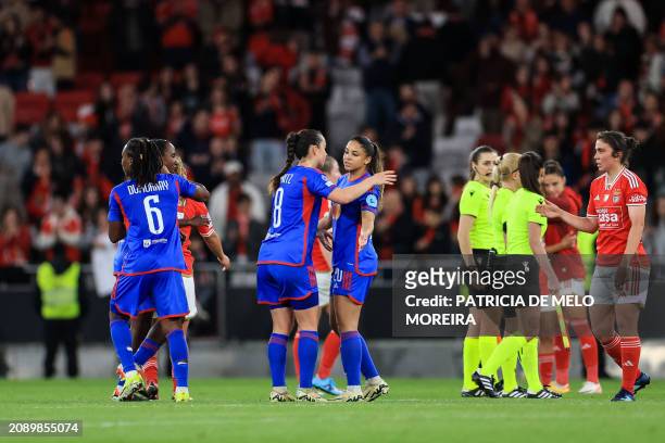 Lyon's German midfielder Sara Dabritz celebrates victory with Lyon's French forward Delphine Cascarino at the end of the UEFA Women's Champions...