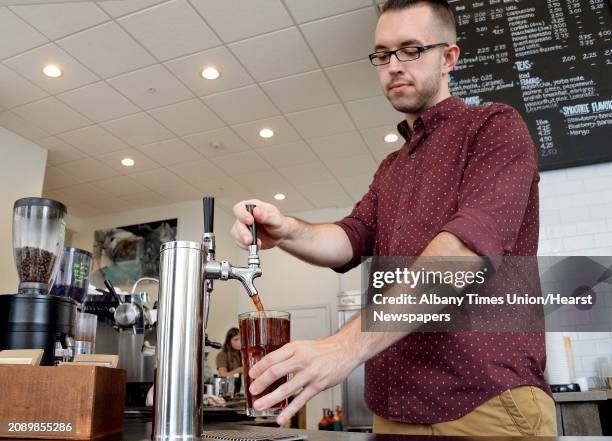 Barista Patric Mullins draws a glass of cold-brew coffee at Stacks Espresso Thursday Sept. 6, 2018 in Albany, NY.