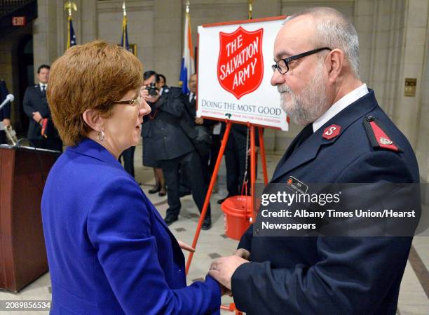 Mayor Kathy Sheehan greets Major Federico Larrinaga of the Salvation Army of Albany during a ceremony at City Hall to launch their Annual Red Kettle...