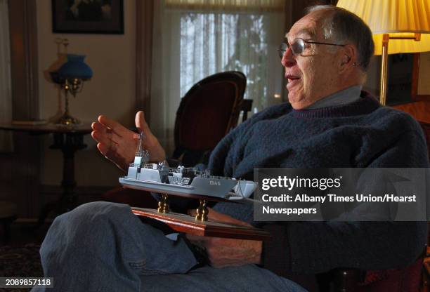 Times Union staff photo by John Carl D'Annibale: Charles Merriam holds a model of an LST, like the one he skippered in the Pacific Theater during...