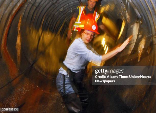 Times Union staff photo by John Carl D'Annibale: Times Union writer Cathy Woodruff makes her way through the 1800 foot drainage culvert under I890 in...