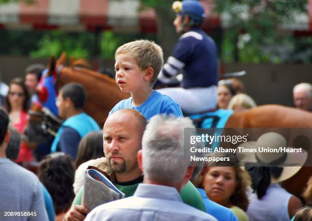 Times Union staff photo by John Carl D'Annibale: 3-year-old Julian Howard rides on father Sean Hward's shoulders as they check out horses in the...