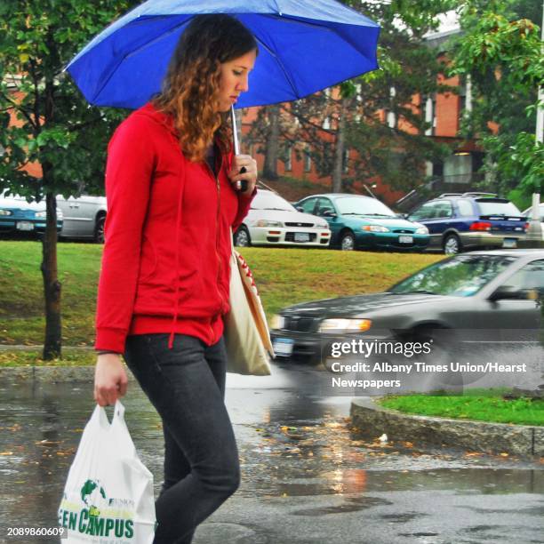 Photo by John Carl D'Annibale /Albany Times Union via Getty Images-- Union College Student Beth Culp navigates through puddles and splashing cars as...