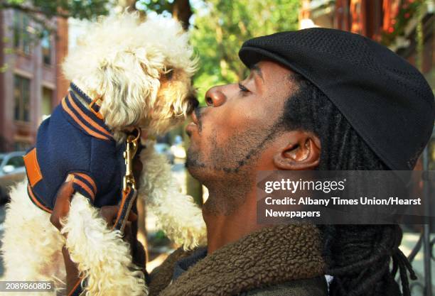 Photo by John Carl D'Annibale /Albany Times Union via Getty Images-- Winston Wolfe of Albany gives his dog "Beboy" a kiss outside their Elm Street...