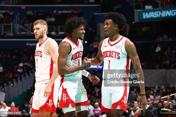 Jalen Green and Amen Thompson of the Houston Rockets high five during the game against the Washington Wizards on March 19, 2024 at Capital One Arena...