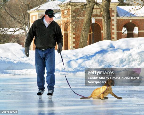 Jeff Strack of Glens Falls ice skates with puppy, "Lily" at Saratoga Spa State Park in Saratoga Springs Tuesday February 24, 2009. Her first time on...