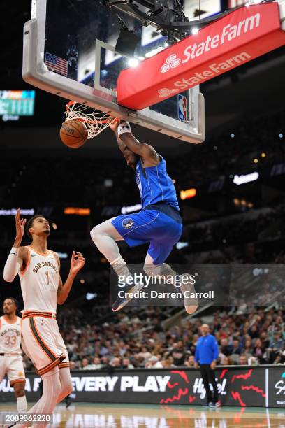 Kyrie Irving of the Dallas Mavericks dunks the ball during the game against the San Antonio Spurs on March 19, 2024 at the Frost Bank Center in San...