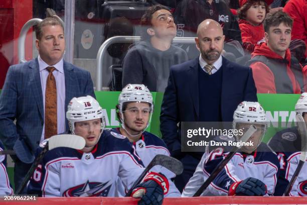 Head Coach Pascal Vincent of the Columbus Blue Jackets and Assistant Coach Mark Recchi watches the action from the bench against the Detroit Red...