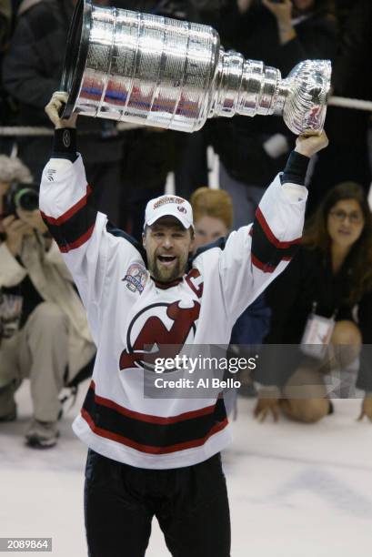 Mike Rupp of the New Jersey Devils hoists the Stanley Cup after News  Photo - Getty Images