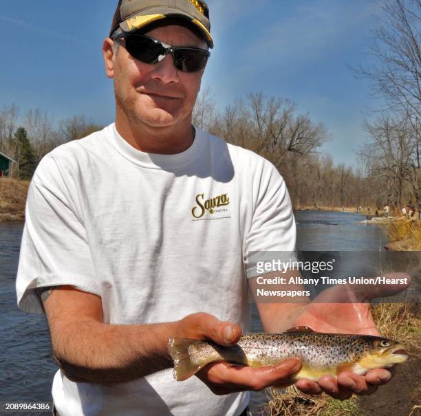 Marty DeSantis of Scotia with a brown trout caught from the Kayaderosseras Creek in William Kelley Park in Ballston Spa Thursday afternoon April 1,...