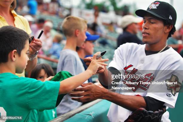 Jorge De Leon of the Valley Cats signs an autograph for 6-yr-old Josh Foglia of Latham before the June 26 game against the Lowell Spinners at the Joe...