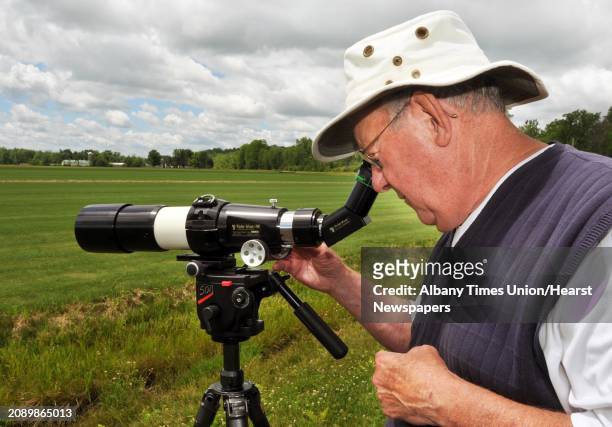 President of the Hudson Mohawk Bird Club, Gary Goodness of Guilderland uses a high power spotting scope to watch migrating sandpipers in the fields...