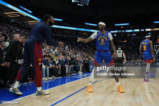 Kentavious Caldwell-Pope high fives DeAndre Jordan of the Denver Nuggets during the game against the Minnesota Timberwolves on March 19, 2024 at...