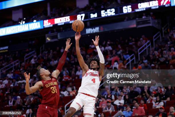 Jalen Green of the Houston Rockets shoots a basket over Isaac Okoro of the Cleveland Cavaliers during the second half at Toyota Center on March 16,...