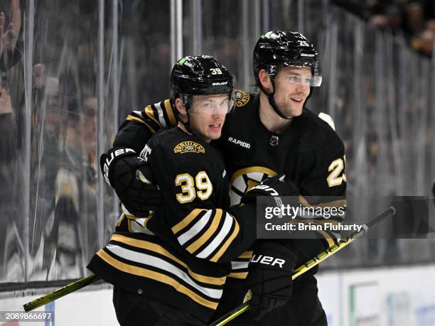 Morgan Geekie of the Boston Bruins celebrates with Brandon Carlo after scoring a goal against the Philadelphia Flyers during the first period at the...