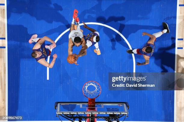 Kentavious Caldwell-Pope of the Denver Nuggets blocks the shot by Kyle Anderson of the Minnesota Timberwolves during the game on March 19, 2024 at...