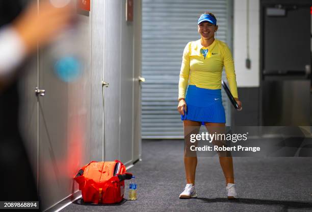 Simona Halep of Romania smiles while warming up before playing against Paula Badosa of Spain in the first round on Day 4 of the Miami Open Presented...