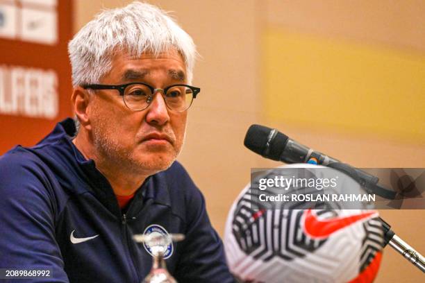 Singapore's Japanese Tsutomu Ogura attends a press conference ahead of the 2026 FIFA World Cup qualifying football match between Singapore and China...