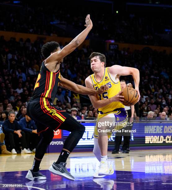 Los Angeles Lakers guard Austin Reaves drives to the basket against Atlanta Hawks forward De'Andre Hunter at Crypto.com Arena on March 18, 2024 in...