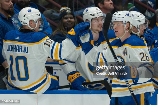 Rasmus Dahlin of the Buffalo Sabres is congratulated by teammates after scoring during their NHL game against the Vancouver Canucks at Rogers Arena...