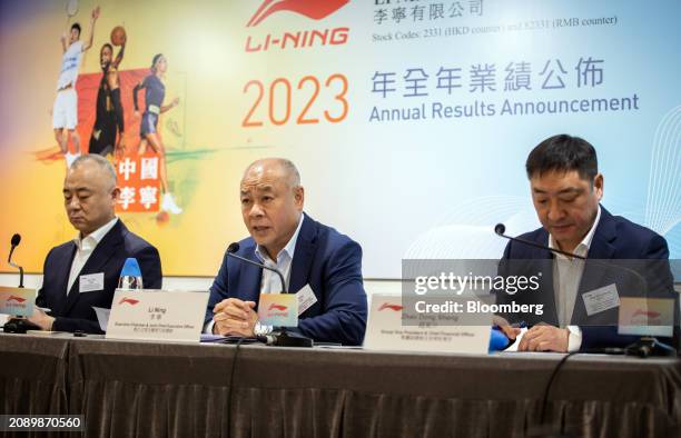 Qian Wei, co-chief executive officer of Li Ning Co., left, Li Ning, chairman and co-chief executive officer, center, and Zhao Dong Sheng, vice...