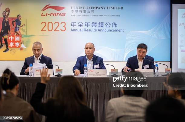 Qian Wei, co-chief executive officer of Li Ning Co., left, Li Ning, chairman and co-chief executive officer, center, and Zhao Dong Sheng, vice...