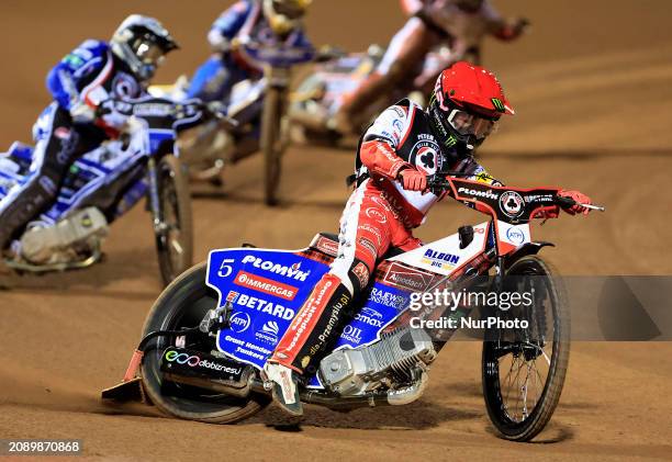 Dan Bewley of Belle Vue Aces is leading Chris Harris of Oxford Spires during the Peter Craven Memorial Trophy meeting at the National Speedway...