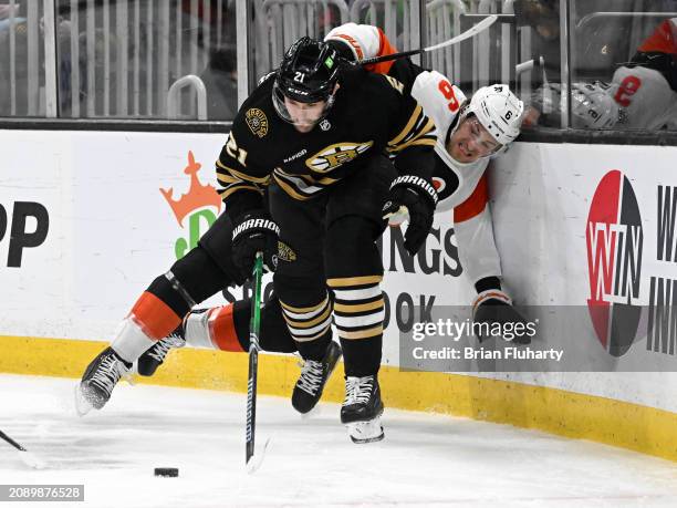 James van Riemsdyk of the Boston Bruins and Travis Sanheim of the Philadelphia Flyers battle for the puck during the first period at the TD Garden on...