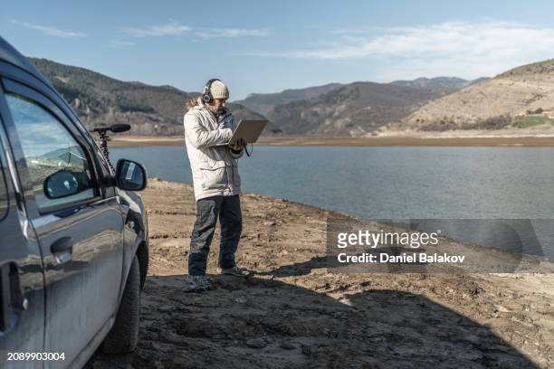 field biologist doing ai driven bioacoustics monitoring. soundscape ecology. - science and transportation committee stock pictures, royalty-free photos & images
