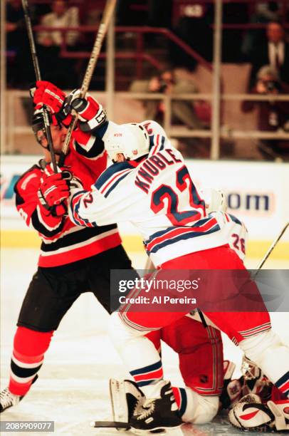 Defenseman Ken Danyeko of the New Jersey Devils battles with Right Wing Mike Knuble of the New York Rangers in the game between the New Jersey Devils...