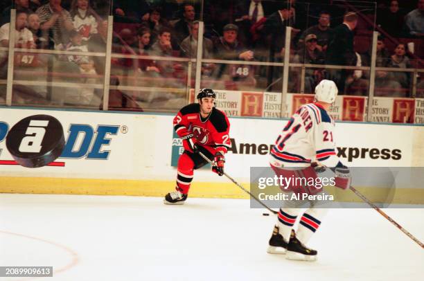 Center Scott Gomez of the New Jersey Devils moves the puck in the game between the New Jersey Devils vs the New York Rangers at Madison Square Garden...