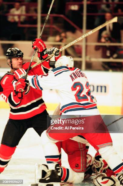 Defenseman Ken Danyeko of the New Jersey Devils battles with Right Wing Mike Knuble of the New York Rangers in the game between the New Jersey Devils...
